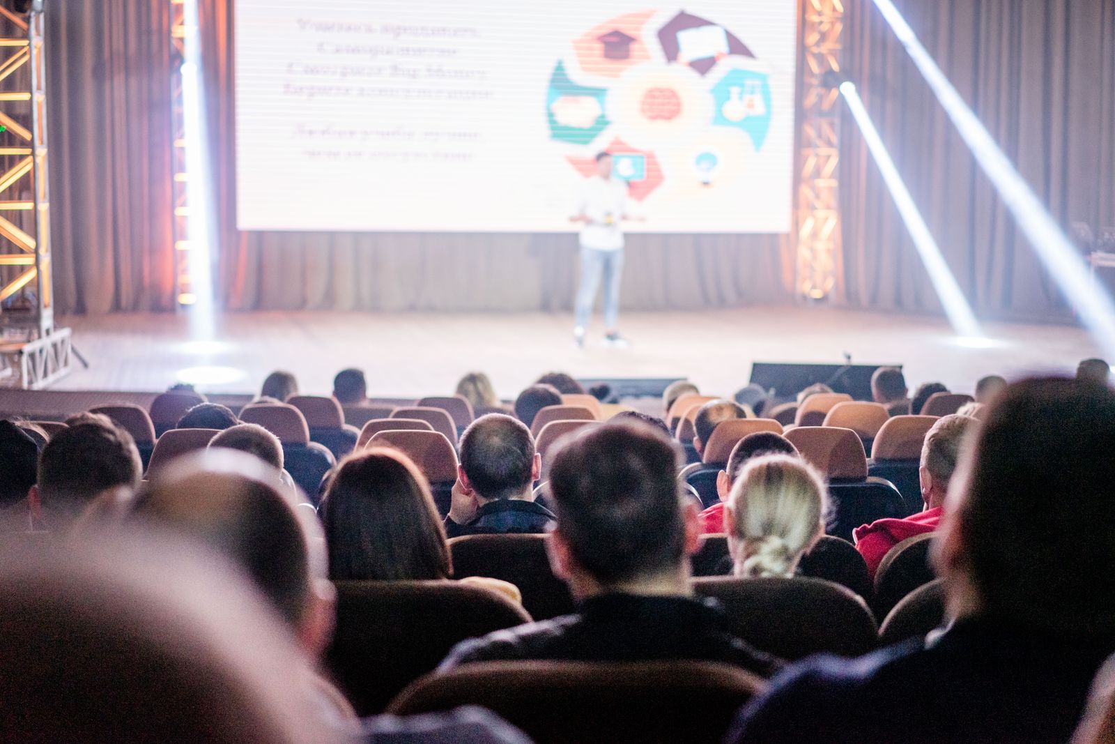 An audience seated in a conference auditorium