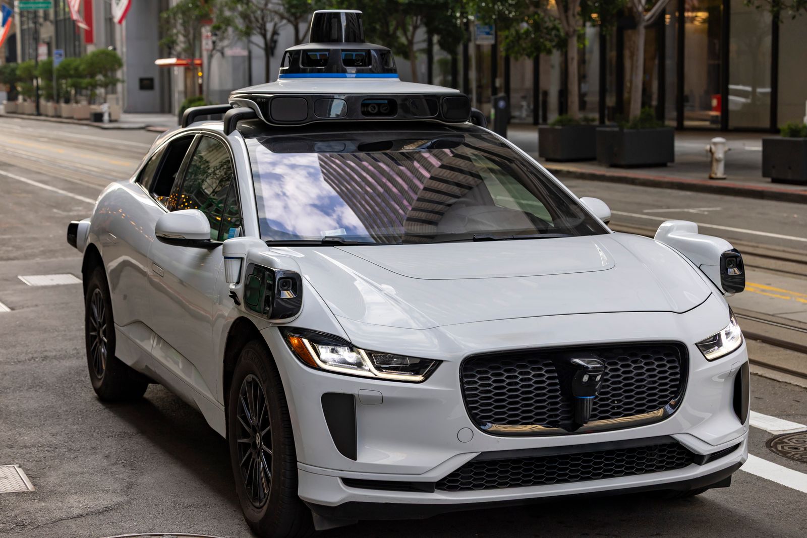 A self-driving car with sensors driving on a city street