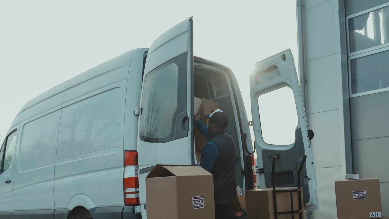 Courier loading packages into a delivery van